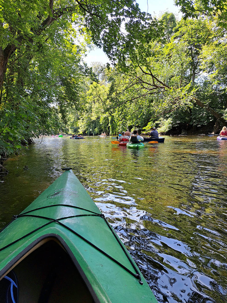 Kayakers floating along the Thornapple River near Whispering Waters Campground in Hastings, Michigan